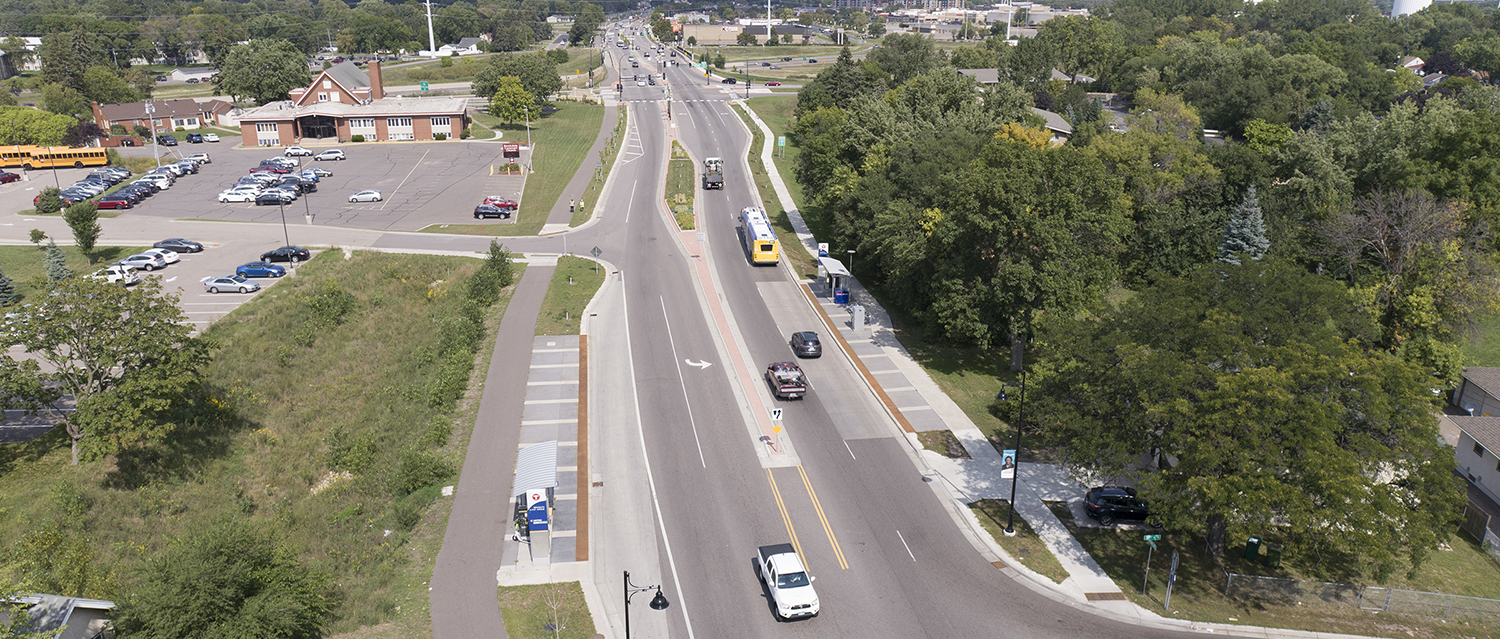 Streetscape view of Brooklyn Boulevard in Brooklyn Center, MN, featuring wide sidewalks, landscaped medians, and lane configurations designed for multimodal transportation and safety.