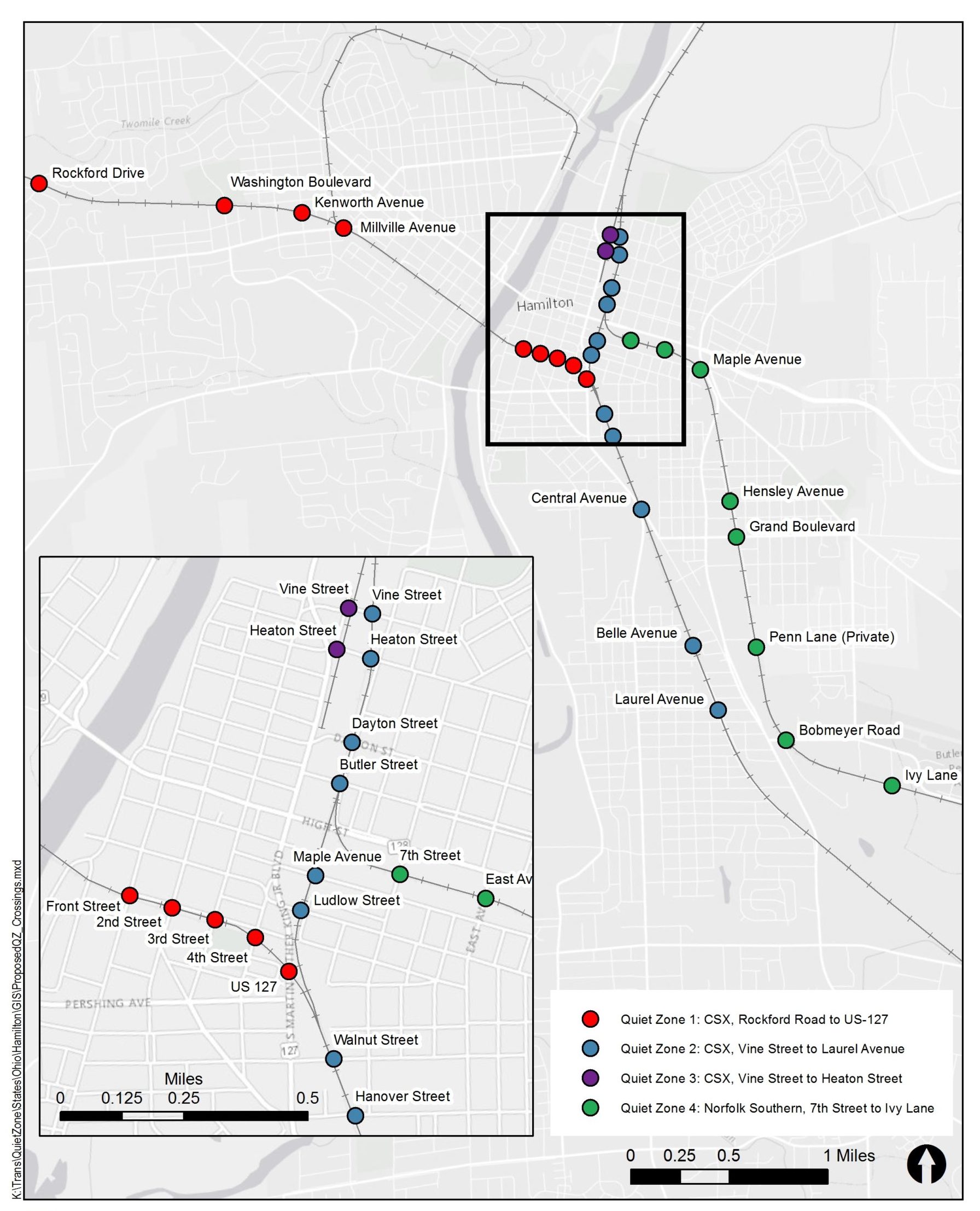 View of a railroad crossing in Hamilton, Ohio, showing signal equipment, pavement markings, and adjacent residential area evaluated for quiet zone improvements.