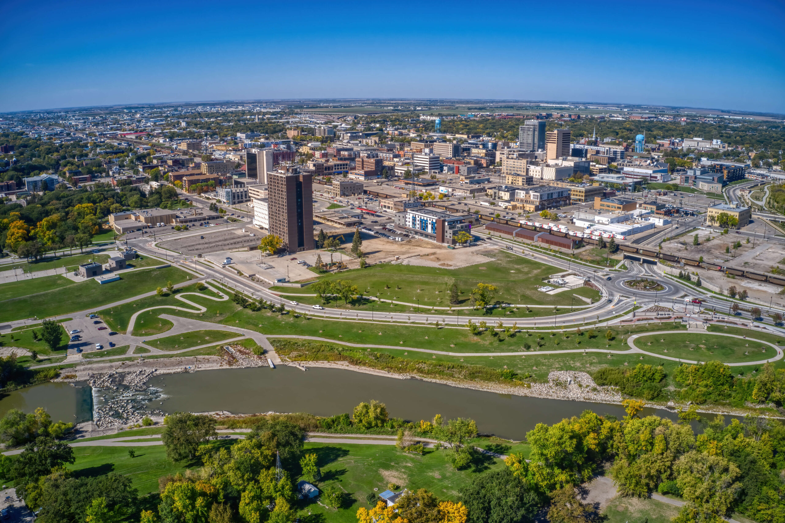 Fargo skyline banner image used on the SRF Consulting Fargo location page, featuring iconic buildings against a blue sky, symbolizing the firm’s engineering, planning, and design expertise in enhancing urban infrastructure and community development in Fargo, North Dakota.